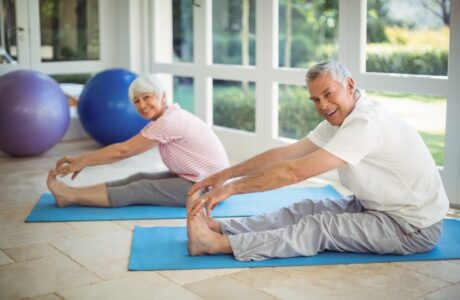A picture of two older adults in a flexibility training class